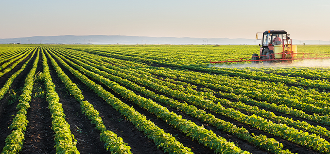 Tractor fertilizing crops