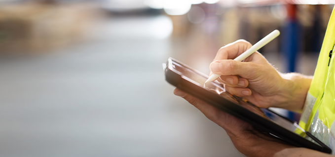 Employee reviewing documentation on handheld device