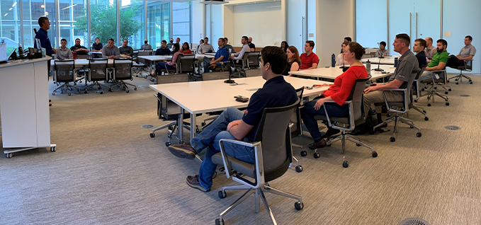 A group of employees sitting in a meeting