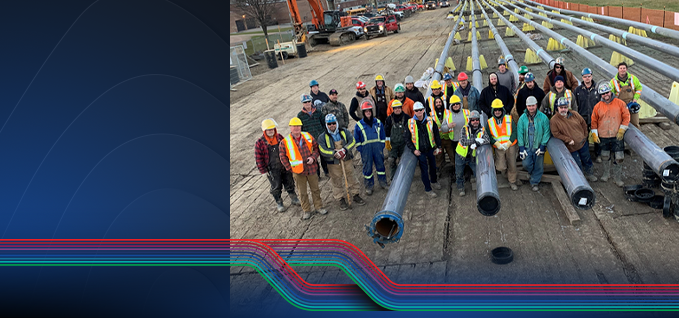 Overhead view of pipeline workers in a workyard