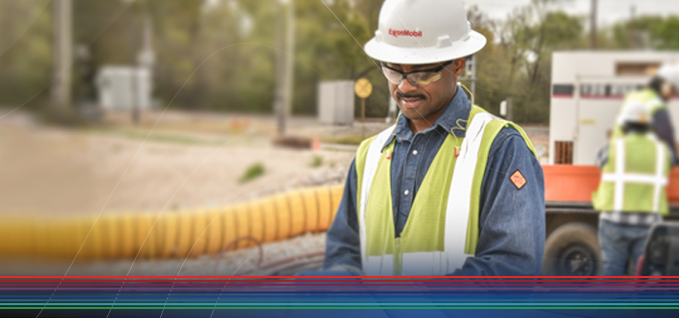 Worker checking levels in a field