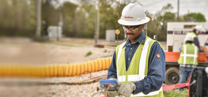 Worker checking levels in a field