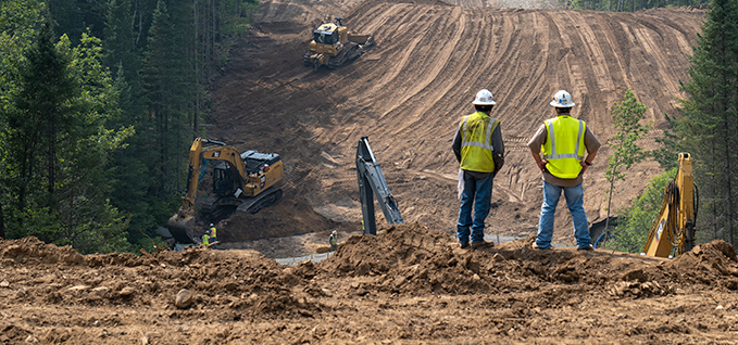 Two workers overseeing a construction site