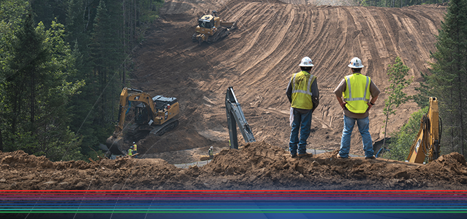 Two workers overseeing a construction site