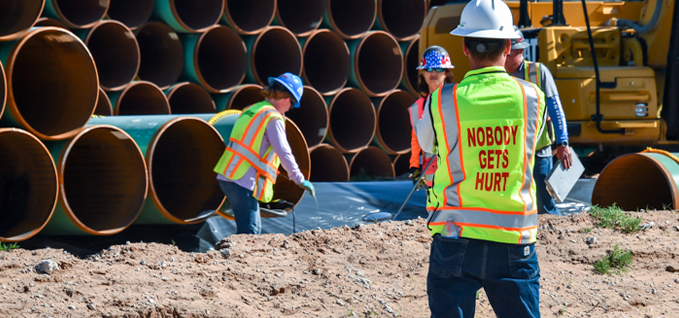 Employee wearing Nobody Gets Hurt safety vest on worksite